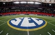 FILE - In this Dec. 5, 2014, file photo, the SEC logo is displayed on the field ahead of the Southeastern Conference championship football game between Alabama and Missouri in Atlanta. The Southeastern Conference will play only league games in 2020 to deal with potential COVID-19 disruptions, a decision that pushes major college football closer to a siloed regular season in which none of the power conferences cross paths(AP Photo/John Bazemore, File)