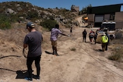 Attendees pull damaged fiber optic cables during the Tribal Broadband Bootcamp held on co-founder Matthew Rantanen's ranch in Aguanga, Calif., Wednesday, June 19, 2024. More than one in five homes on tribal lands lack access to adequate broadband, compared to fewer than one in 10 on non-tribal land in 2024, according to Federal Communications Commission data. But experts say the disparity is likely greater. (AP Photo/Jae C. Hong)