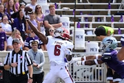 Troy wide receiver Chris Lewis (6) makes a one-handed catch for a touchdown while being defended by Kansas State cornerback Will Lee III (8) during the first half of an NCAA college football game in Manhattan, Kan., Saturday, Sept. 9, 2023. (AP Photo/Reed Hoffmann