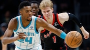 Charlotte Hornets forward Brandon Miller (24) controls the basketball after forcing a turnover by Toronto Raptors guard Gradey Dick (1) during the second half of an NBA basketball game in Charlotte, N.C., Wednesday, Feb. 7, 2024. (AP Photo/Nell Redmond)