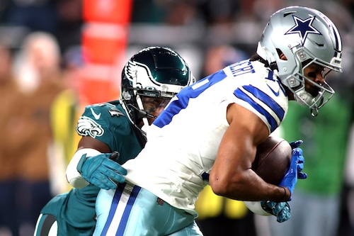 Dallas Cowboys wide receiver Jalen Tolbert holds on for a reception against the coverage by Philadelphia Eagles cornerback James Bradberry