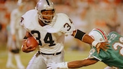 Los Angeles Raiders running back Bo Jackson (34) pushes away Miami Dolphins corner back Tim McKyer (22) during the third quarter of game in Miami's Joe Robbie stadium, Nov. 20, 1990. (AP Photo/Beth Keiser)