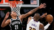 Brooklyn Nets forward Noah Clowney (21) defends against Los Angeles Lakers forward LeBron James (23) during the second half of an NBA basketball game Sunday, March 31, 2024, in New York. (AP Photo/John Munson)