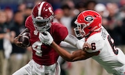 Alabama quarterback Jalen Milroe (4) runs the ball against Georgia defensive back Daylen Everette (6) during the first half of the Southeastern Conference championship NCAA college football game in Atlanta, Saturday, Dec. 2, 2023.