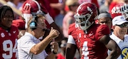 Alabama head coach Nick Saban talks with quarterback Jalen Milroe (4) during the first half of an NCAA college football game against Mississippi, Saturday, Sept. 23, 2023, in Tuscaloosa, Ala.