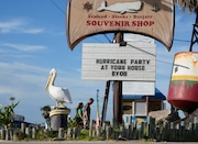 Visitors pass a restaurant closed in advance of Beryl, Saturday, July 6, 2024, in Port Aransas, Texas. (AP Photo/Eric Gay)