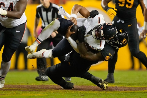 Washington Commanders defensive tackle Jonathan Allen sacks Chicago Bears quarterback Justin Fields