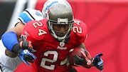 Tampa Bay Buccaneers running back Cadillac Williams (24) finds an opening as Detroit Lions linebacker DeAndre Levy (54) tries to bring him down during an NFL football game between the Buccaneers and the Lions Sunday in Tampa, Fla, December 19, 2010. The Lions defeated the Buccaneers 23-20 in overtime. (AP/Margaret Bowles)