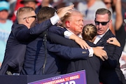 FILE - Republican presidential candidate former President Donald Trump is surrounded by U.S. Secret Service agents as he is helped off the stage at a campaign rally in Butler, Pa., July 13, 2024.  (AP Photo/Gene J. Puskar, File)