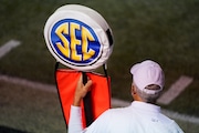 A member of the chain gang holds a marker with the SEC logo in the second half of an NCAA college football game between Vanderbilt and LSU Saturday, Oct. 3, 2020, in Nashville, Tenn. (AP Photo/Mark Humphrey)